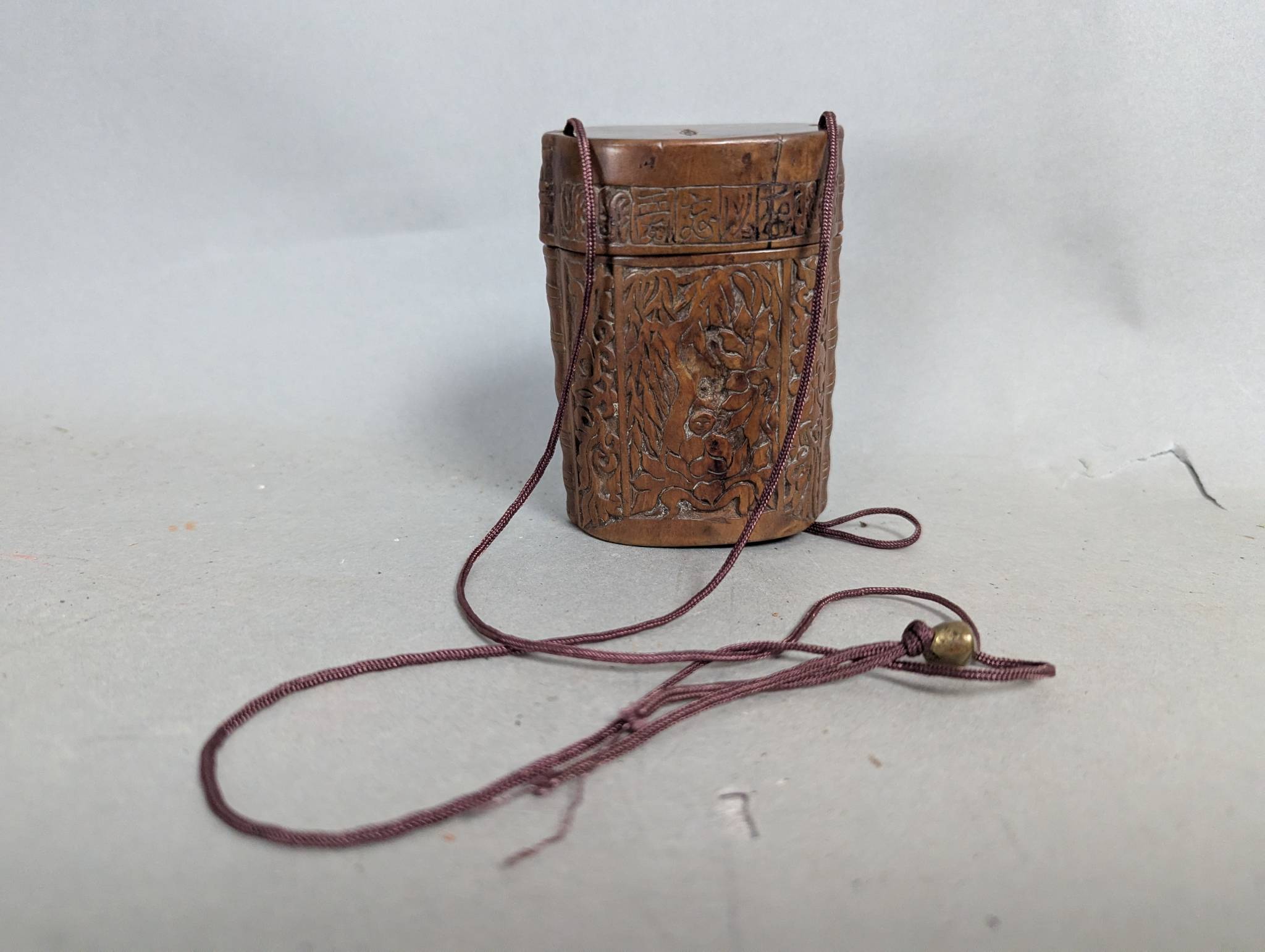 Japanese Carved Wooden Inro with Traditional Motifs and Cord