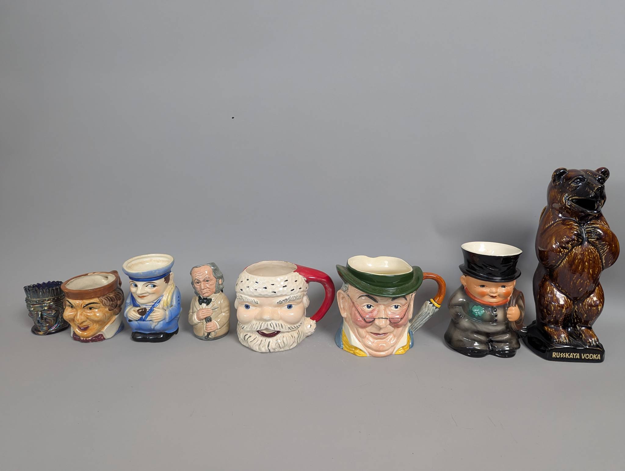 Lot 8 Ceramic Character Mugs and Russkaya Vodka Bear Pitcher