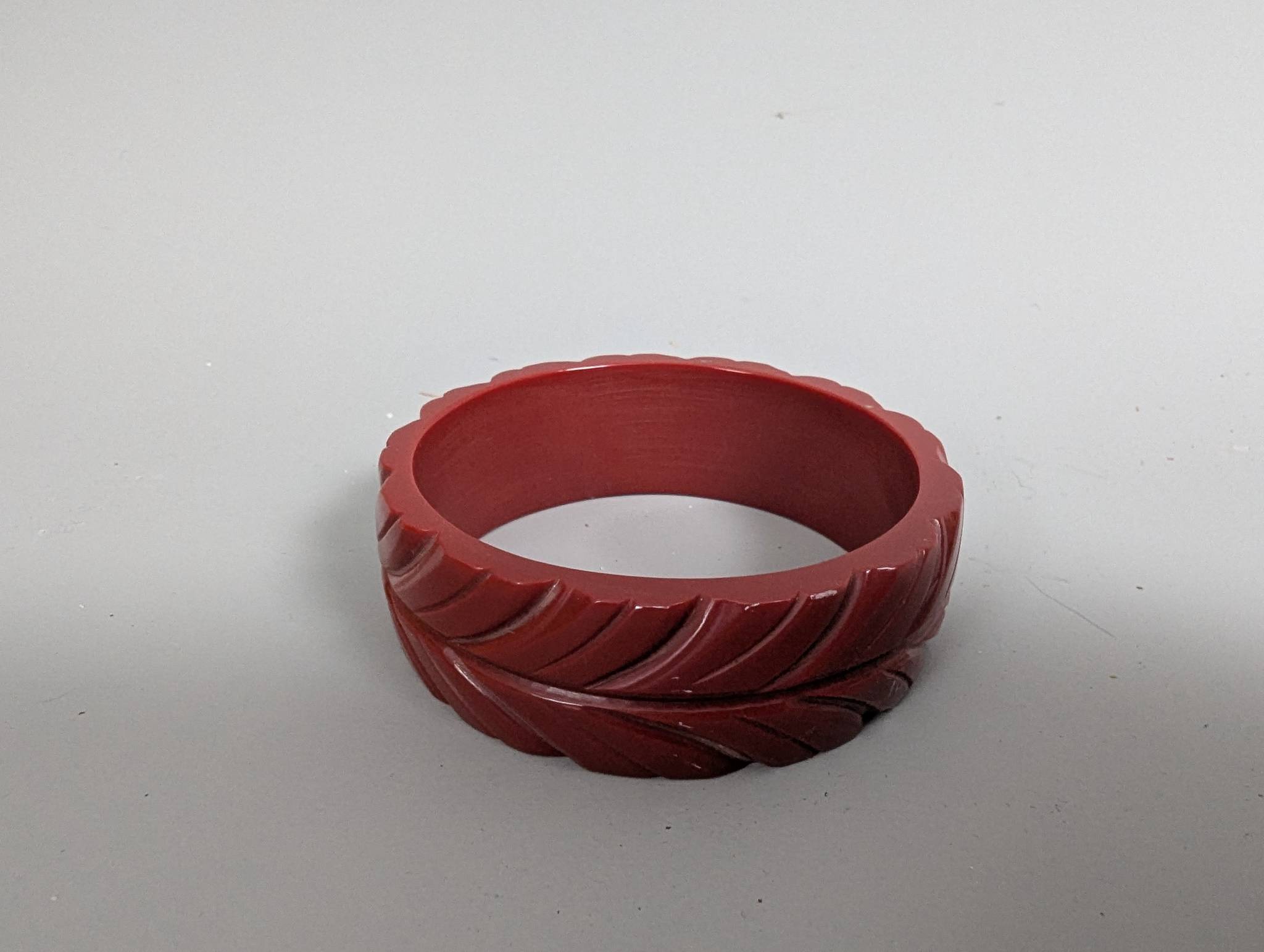 Art Deco Cherry Red Bakelite Bangle with Leaf Carvings